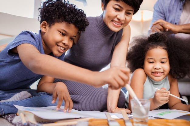 Happy African American family with children painting together at home