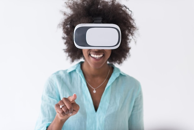 Happy african american girl getting experience using VR headset glasses of virtual reality, isolated on white background