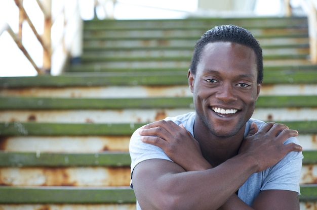 Happy african american male smiling with arms crossed
