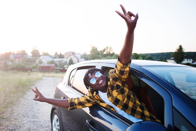 Happy african american woman in a car, lifestyle