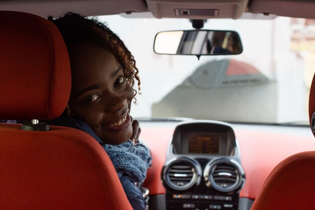 happy African-American woman in car
