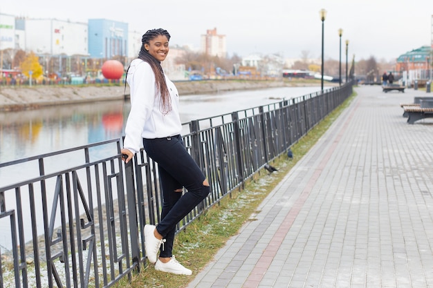 The happy African American woman in a full-length Park