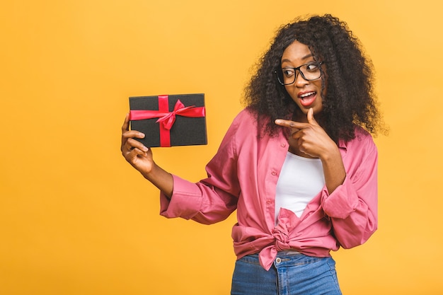 Happy african american woman holding present