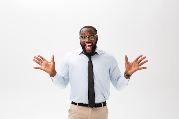 Happy african businessman wearing a corporate grey shirt and black tie punching the air with his fists arms in air smiling and shouting in victorious success for his business deal