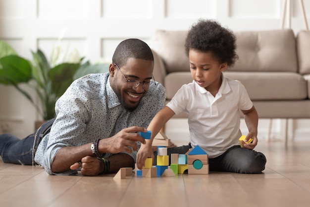 happy african dad and child son building constructor from blocks