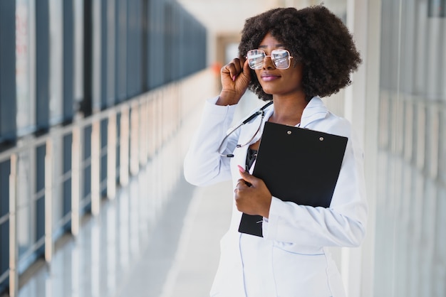 Happy african doctor using tablet computer