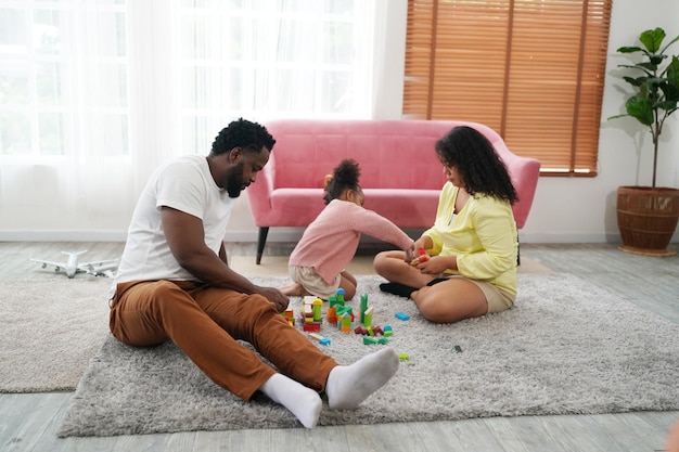 Happy african family having playful time at home Family love Parents and toddler indoor