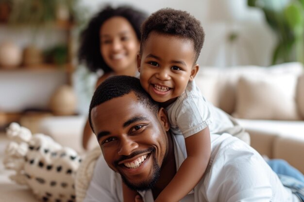 Happy African and Indian parents playing with son at home