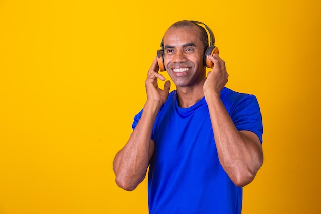 Happy African man smiling listening to music on headphones