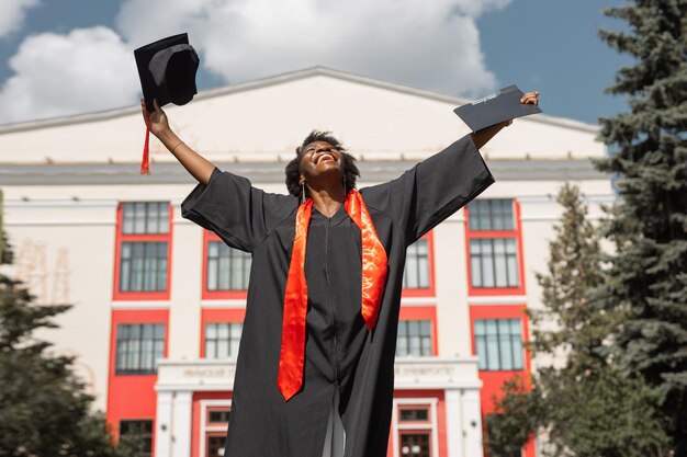 happy african woman student with hands up