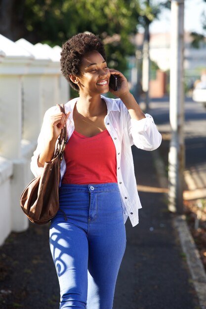 Happy african woman talking on mobile phone