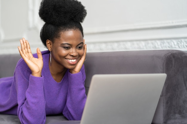 Happy afro-american woman waving hi greeting gesture