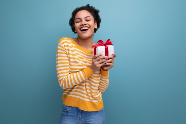 Happy afro brunette s latin young woman with gift