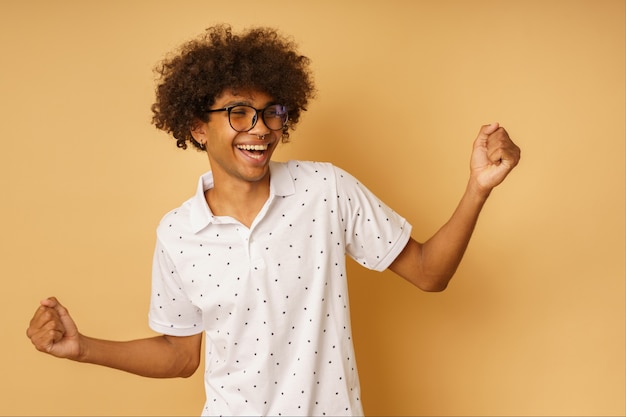 Happy afro man makes the victory gesture