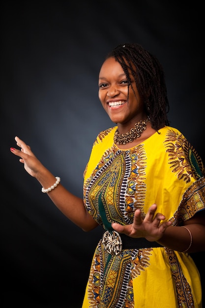 Happy afro women is dancing and posing in the studio