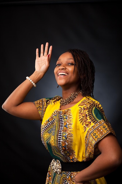 Happy afro women is dancing and posing in the studio