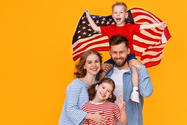 Happy american family with the usa flag celebrates independence day on july 4