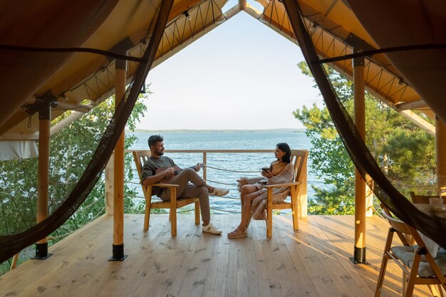 Happy amorous couple relaxing in wooden armchairs