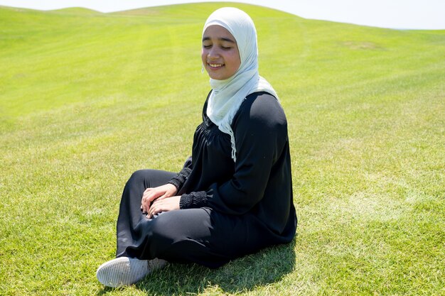 Happy Arabic Muslim girl in beautiful nature