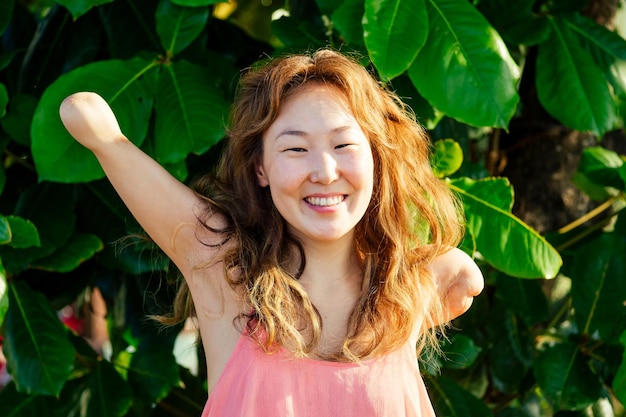 Happy asian armless woman smilimg at the tropical beach