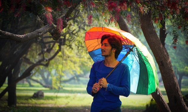 Happy Asian Boy holding Colorful umbrella in summer outdoor