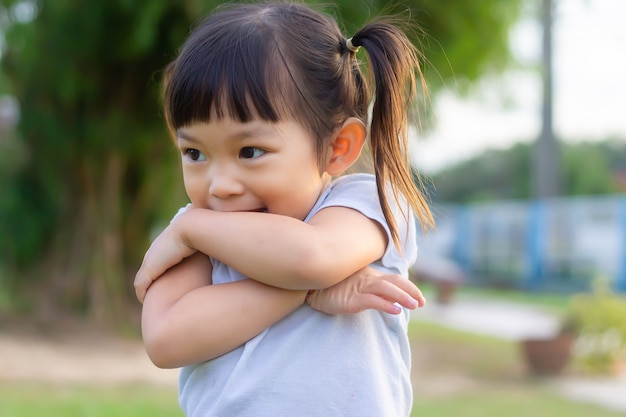 부끄러워하는 행복 한 아시아 아이. 그녀는 공원 놀이터에서 장난감을 가지고 놀고 있습니다. 학습 및 아이 개념.