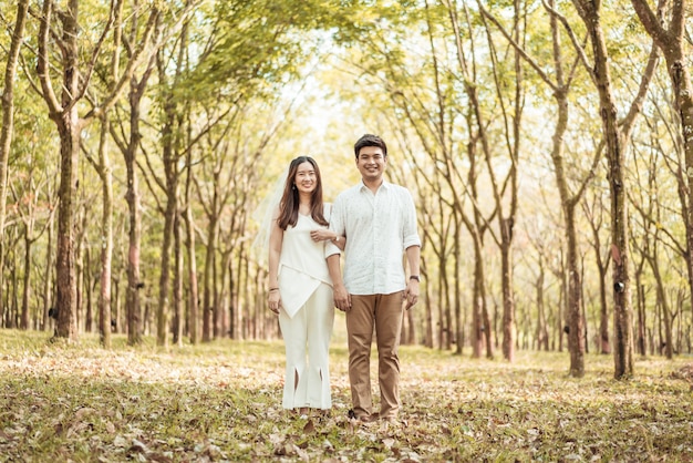 Happy Asian couple in love with tree arch