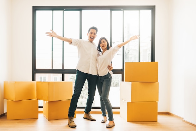 Happy Asian couple on moving day to new house