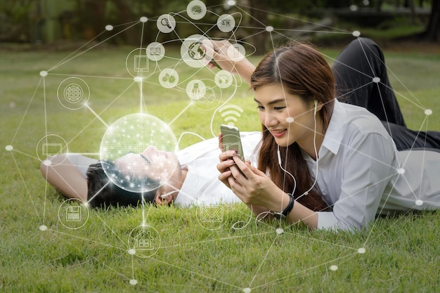 Happy asian couple using and listening the song and using the social network