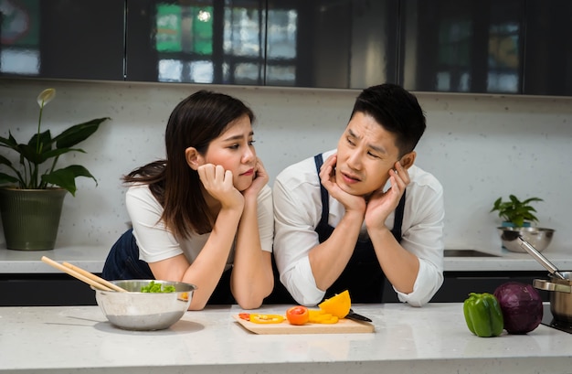 happy of Asian couples chef cooking in kitchen.