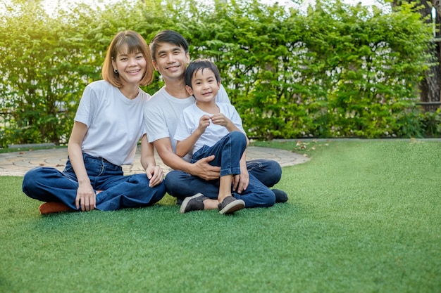 Happy asian family in the backyard on the grass