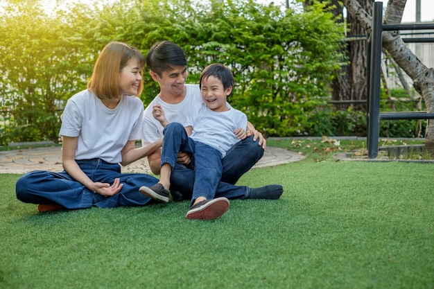 Happy asian family in the backyard on the grass