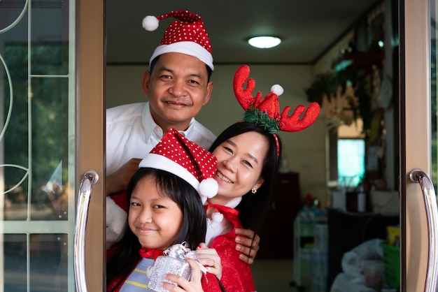 Happy asian family daughter mother and father smiling in christmas day
