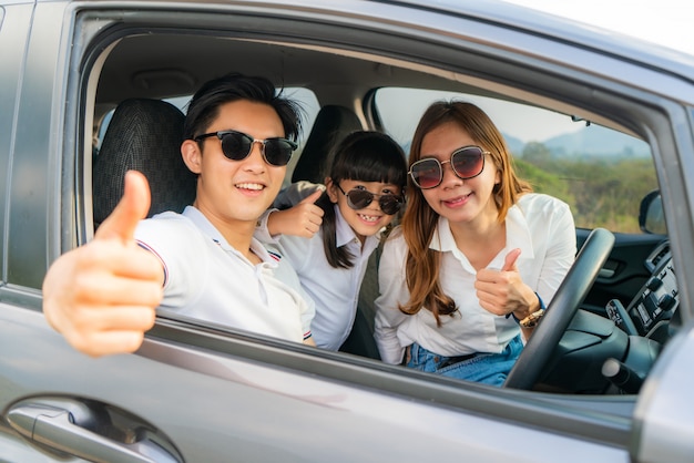 Happy Asian family enjoying a road trip