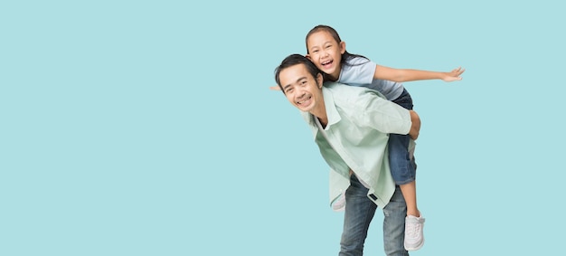 Happy asian family of father and daughter hug spread out your arms isolated on blue background with Clipping paths for design work empty free space