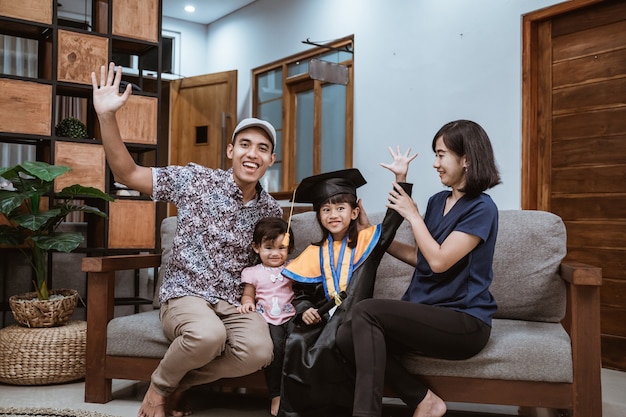 Happy asian family graduate at home elementary school student at home celebrating