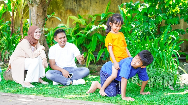 Happy asian family playing together in the park