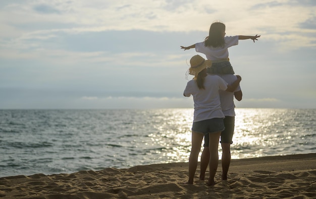 Happy asian family travel on beach on holiday