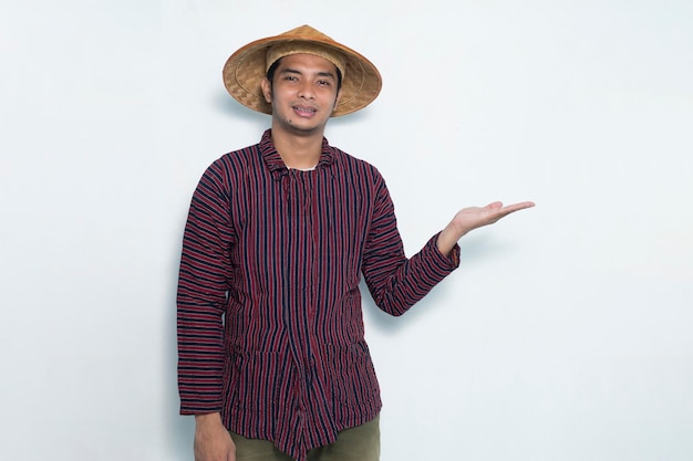 Happy asian farmer pointing with fingers to different directions isolated on white background