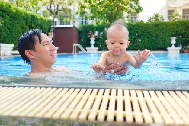 Happy asian father and Cute little Asian 6 months old  baby boy child relaxing 