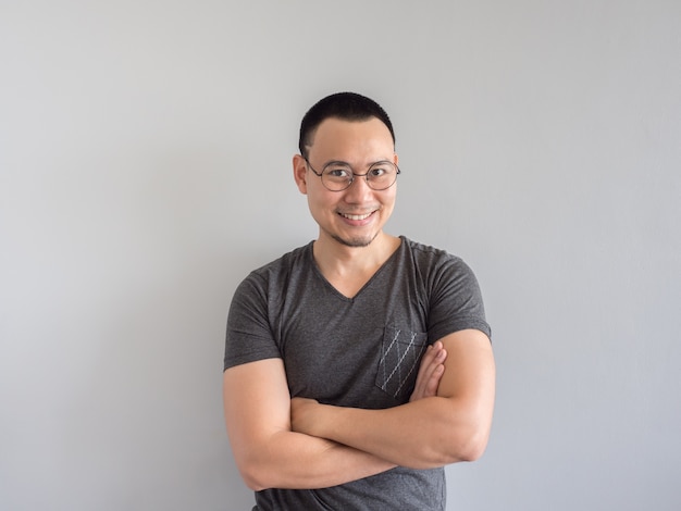 Happy Asian freelance man with skinhead and relaxing mile haircut.