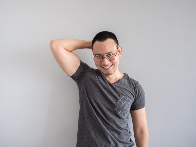 Happy Asian freelance man with skinhead and relaxing mile haircut.