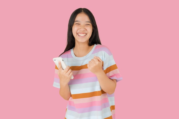 The happy Asian girl has a smartphone in her hand