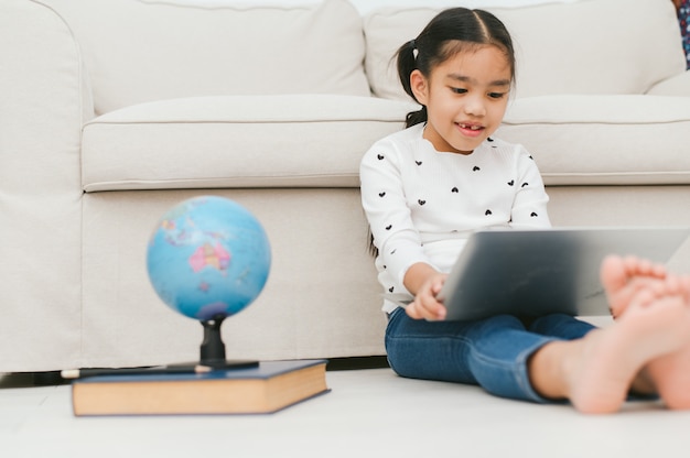 Happy Asian girl using laptop computer