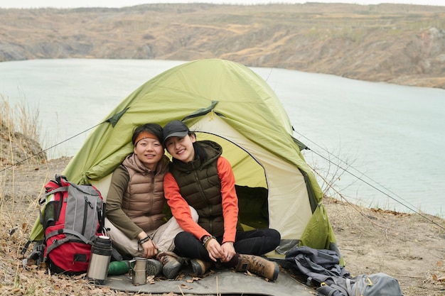 Happy asian girlfriends in camp