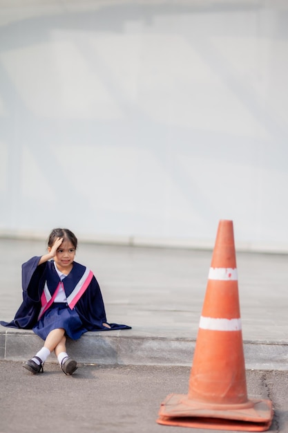 Happy Asian girls in graduation gowns on their graduation day at schoolGraduation concept with copy spacex9