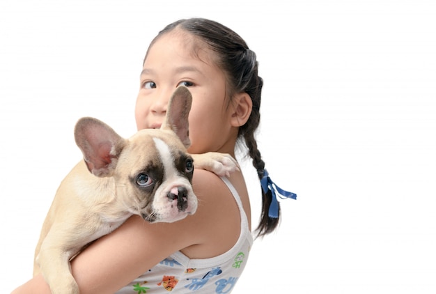 Happy asian kid girl holding french bulldog 