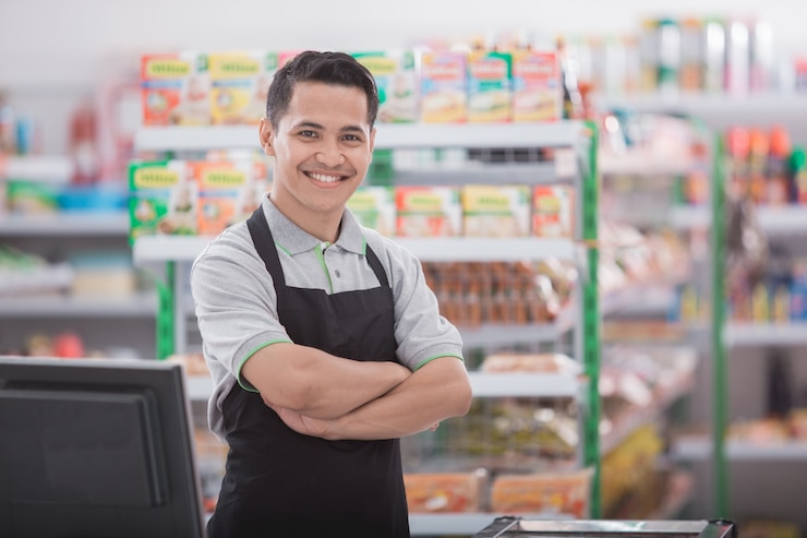 Photo happy asian male shopkeeper