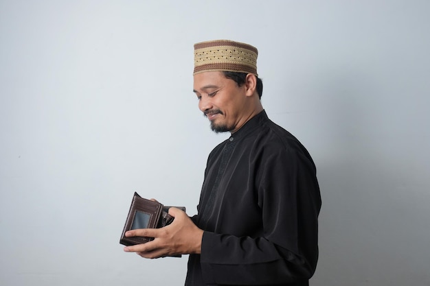 Happy asian muslim man checking his wallet