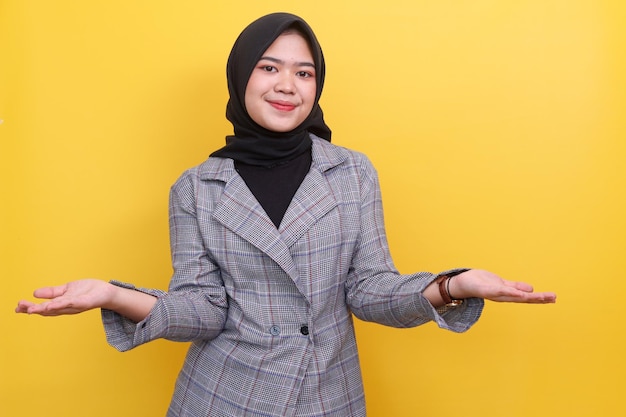 Happy Asian muslim woman gesture presenting greeting and welcoming showing open hand with copy s